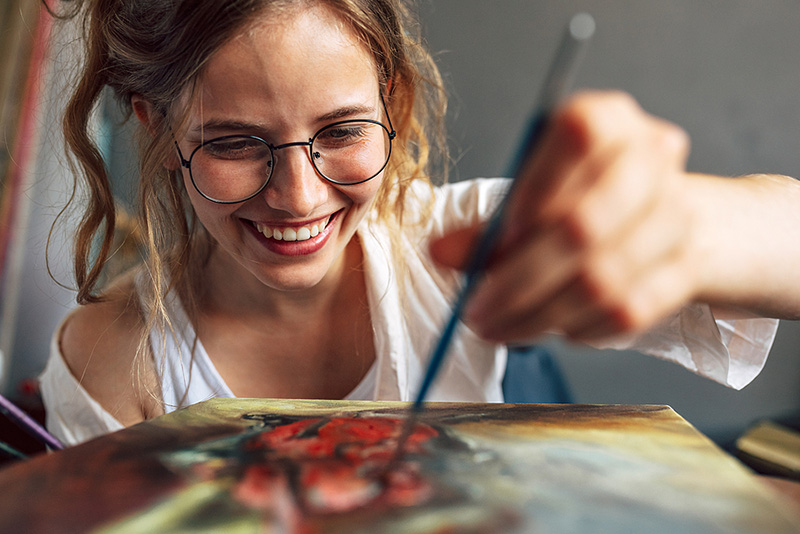Smiling Woman Painting