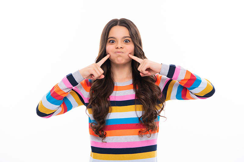 girl pointing to teeth grinding