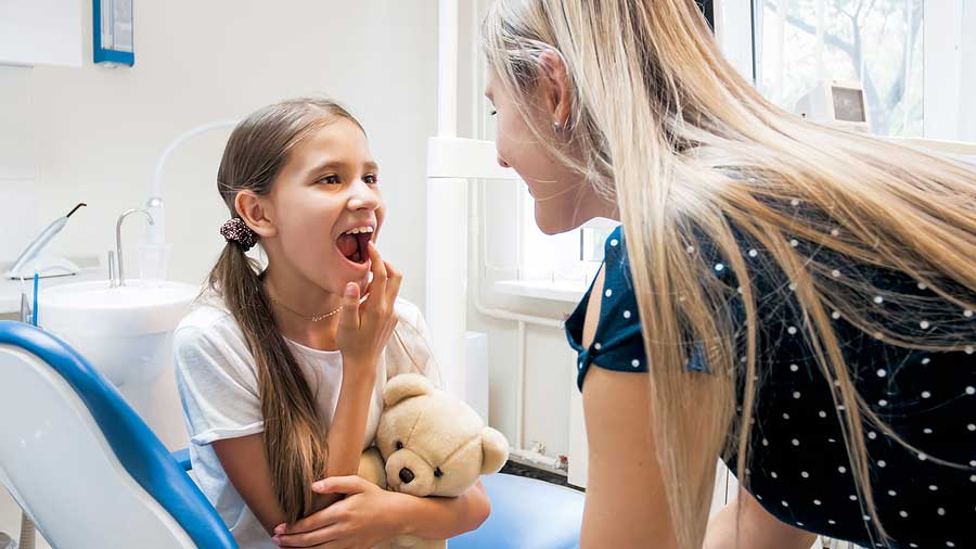 Little girl showing her teeth after treatment