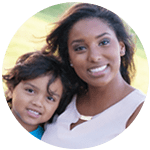 Woman huggin young boy both are smiling