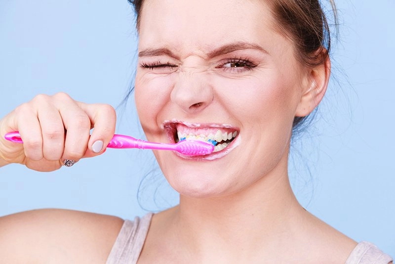 Woman Brushing Her Teeth